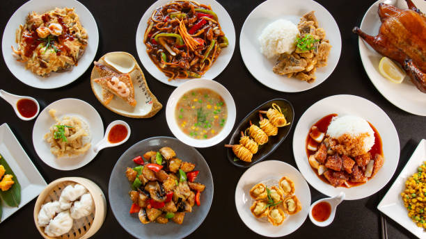 Top view food platter combo set of traditional Cantonese yum-cha Asian gourmet cuisine Top view food platter combo set of traditional Cantonese yum-cha Asian gourmet cuisine meal food dish on the white serving plate on the table, includes dishes of duck, pork, fish, chicken, vegetables chinese food stock pictures, royalty-free photos & images