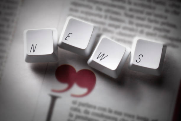 News. Computer keys on the page of the newspaper. stock photo