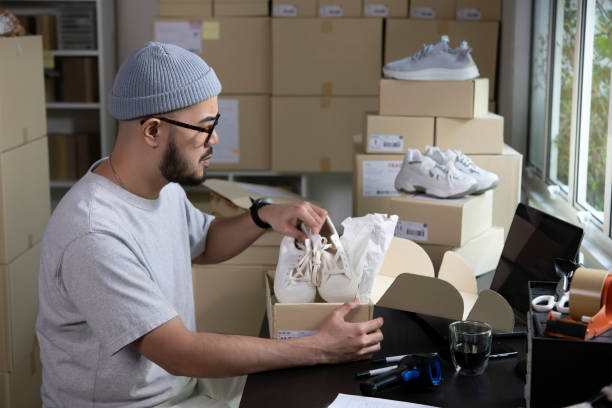 istock Male entrepreneur packaging box for delivery in store warehouse. 1396394516