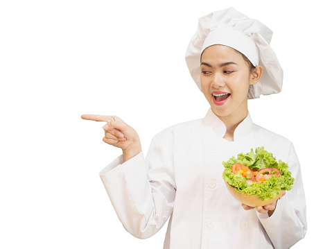 Asian woman in chef's uniform is cooking in the kitchen. portrait female cook smiling with copy space. white background