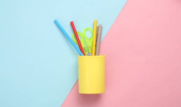 istock Cup with stationery on a blue-pink pastel background. Back to school concept 1396401480