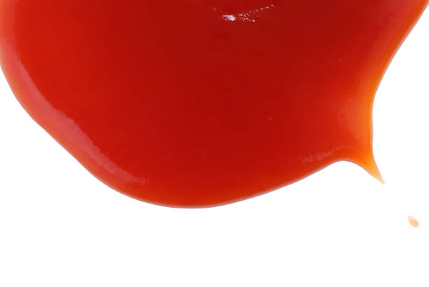 istock Red ketchup isolated on white background with clipping path. tomato sauce texture. from above. 1396403897