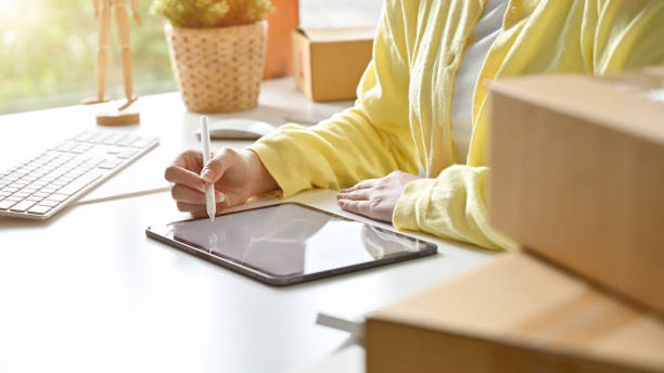istock Female using digital tablet to create her online marketing content. 1396406096