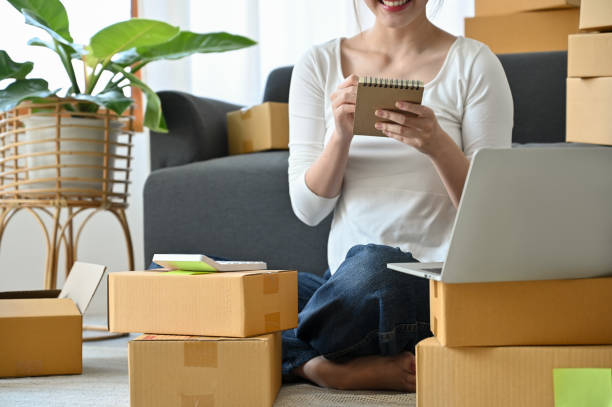 istock Cropped image, Smile female online business owner taking notes on her notepad 1396406307