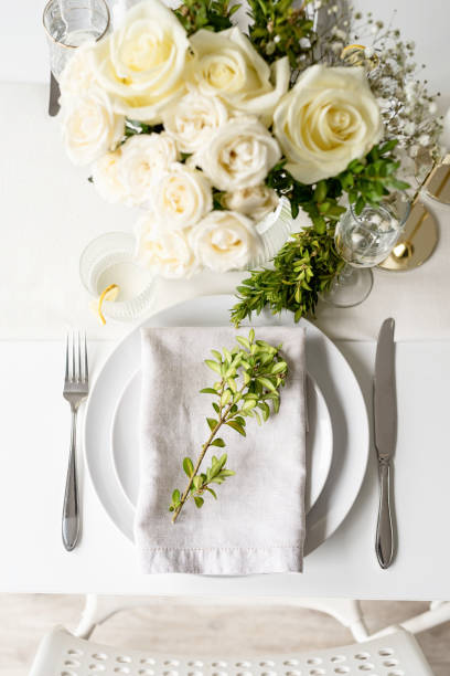 istock The wedding table setting, top view. Wedding teble decoration with white roses and boxwood 1396410724