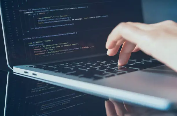 Software technology development concept. Closeup coding on screen, Woman programmer, software engineer hands coding html and programming computer script on laptop