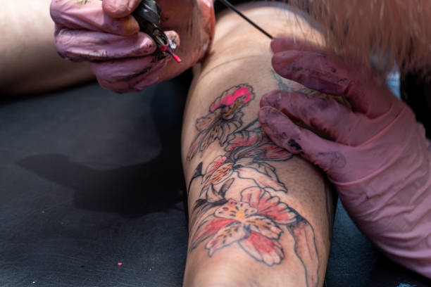 istock Filling the tattoo design with color 1396412986