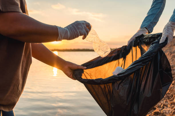 istock woman hand picking up garbage plastic bottle for cleaning at park 1396413671