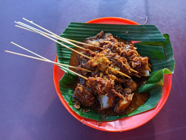 istock Chicken satay and lontong in peanut sauce 1396414412