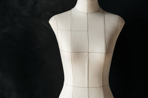 istock Light fabric mannequin of a female figure on a dark 1396414616