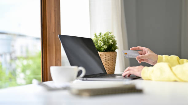 istock Close-up image, Female using laptop and holding a credit card. 1396414840