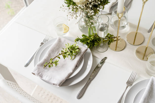 istock The wedding table setting, high angle view . Wedding teble decoration with white roses and boxwood 1396416446