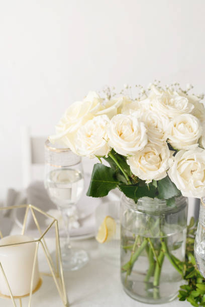 istock The wedding decor. Wedding teble decoration with white roses, closeup 1396418056