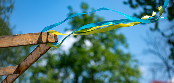 yellow and blue patriotic ribbon fluttering in the wind, Ukrainian ribbon of freedom, colors of the flag of Ukraine as a symbol of courage, freedom and struggle for independence.