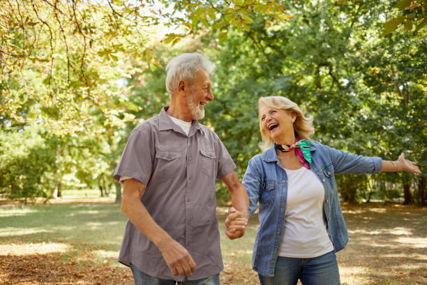 istock Happy senior couple going for a walk in the park 1396419564
