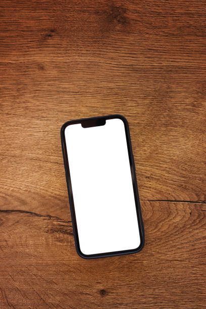 Smartphone with blank white mockup touchscreen on teak wooden table