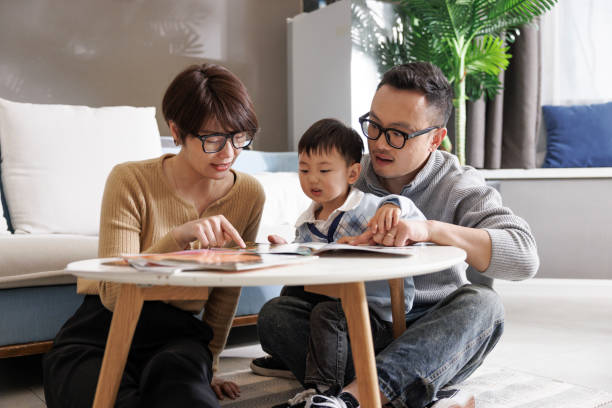 istock Young parents read books with their son 1396420515