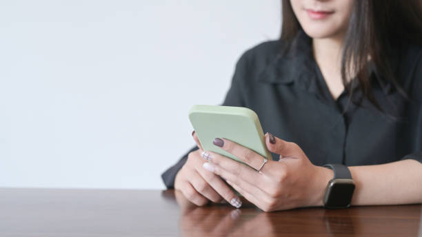 istock Smiling young female office worker using mobile phone. 1396421081