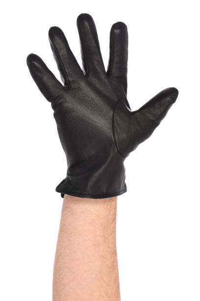 istock Man wearing black leather glove on white background, closeup. 1396422048