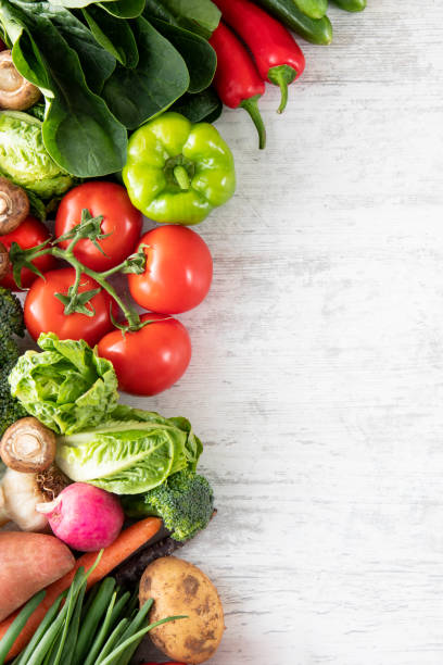 istock Fresh Vegetables on White Wooden Table Background 1396426241
