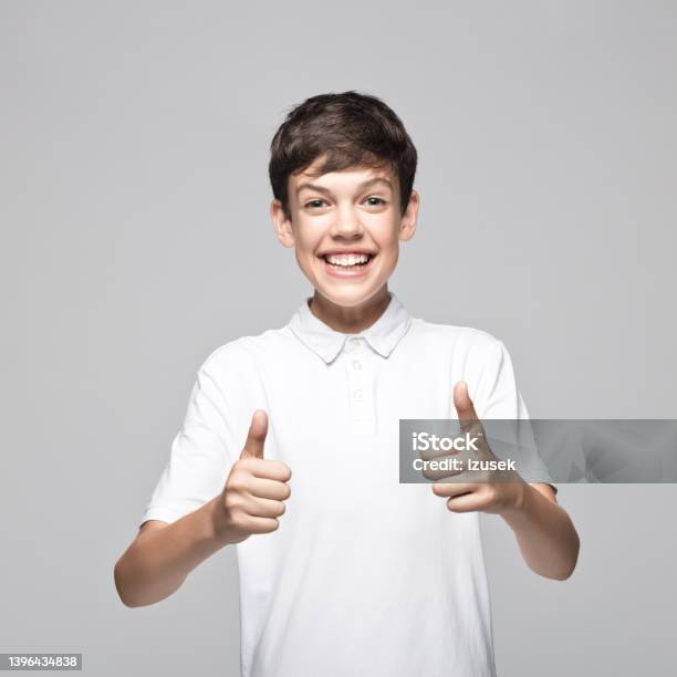 Portrait Of Happy Boy Gesturing Thumbs Up Stock Photo - Download Image Now - Teenager, Adolescence, Cut Out