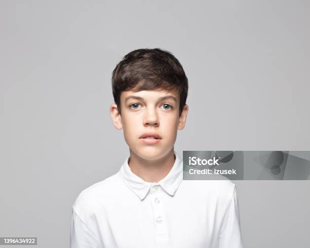 Sad Boy Against Gray Background Stock Photo - Download Image Now - 14-15 Years, Cut Out, Serious