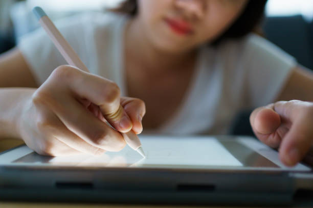 istock Woman drawing an illustration on tablet. 1396434945