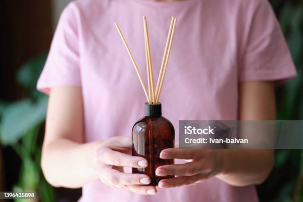 Woman Holds Jar With An Aromatic Diffuser Of Homemade Fragrance In Hands Stock Photo - Download Image Now