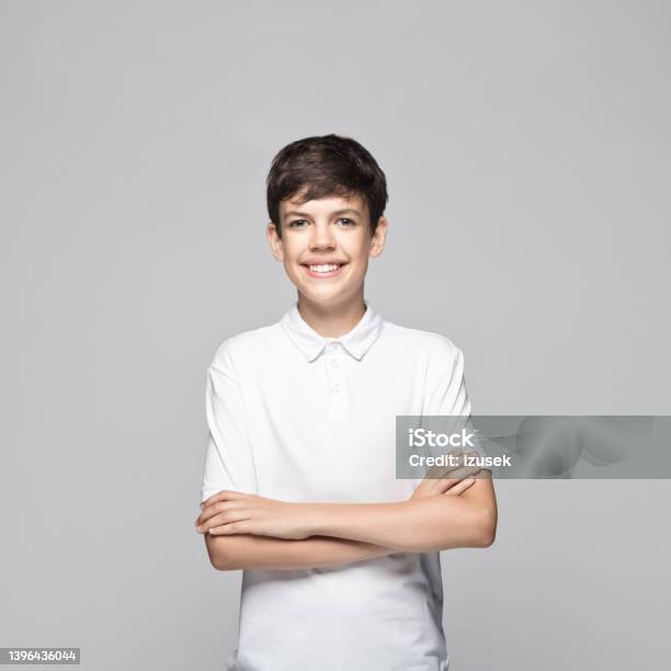 Teenage Boy Standing With Arms Crossed Stock Photo - Download Image Now - 14-15 Years, White Color, Polo Shirt