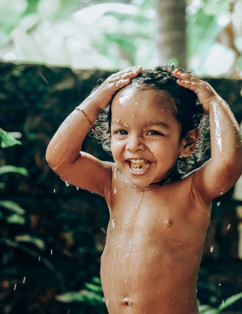 little boy taking bath in tap water stock photo