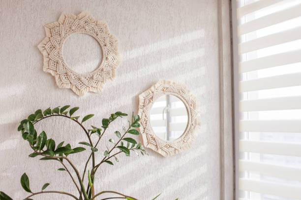 Macrame mirror and wreath on a white wall.  Eco-style. Natural materials. stock photo