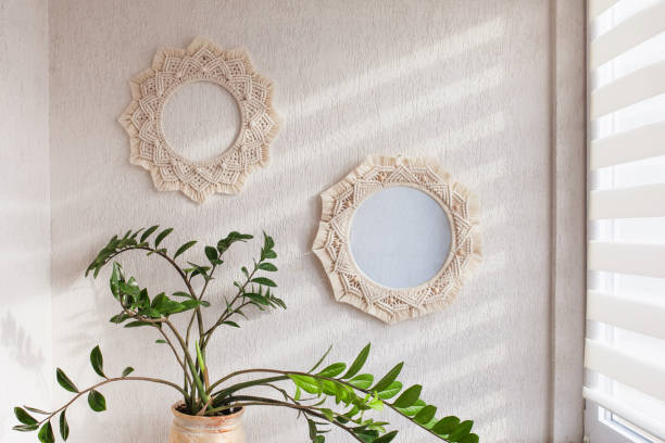 istock Macrame mirror and wreath on a white wall.  Eco-style. Natural materials. 1396437798