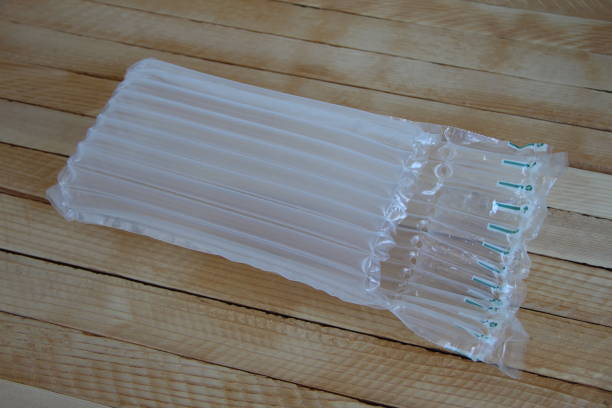 istock Plastic inflatable air shockproof packaging on a wooden background 1396438472