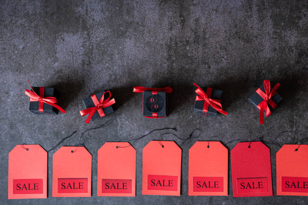 istock Sale labels and black gift boxes lie on a dark gray background. 1396439525