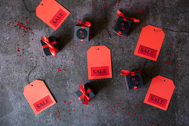 istock Sale labels and black gift boxes lie on a dark gray background 1396439559