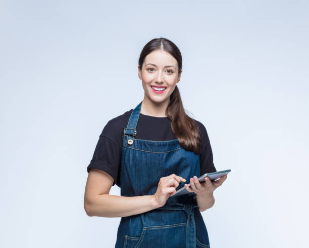 Happy woman with digital tablet against white background stock photo