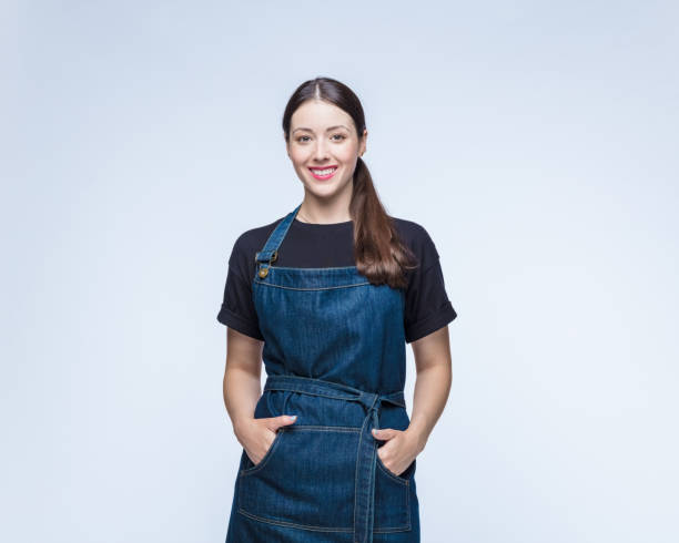 istock Happy woman with hands in pockets against white background 1396439769