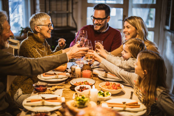 istock Happy multi-generation family toasting while having lunch in dining room. 1396440563