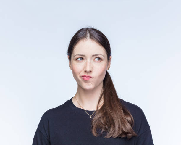 istock Woman making face against white background 1396440584