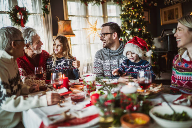 istock Happy extended family talking during New Year's meal at dining table. 1396440646