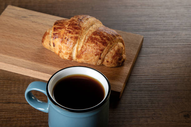 istock Croissant with a cup of full coffee ,directly above 1396441022