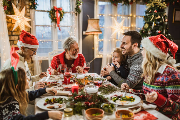 istock Happy extended family having New Year's lunch at dining table. 1396441098