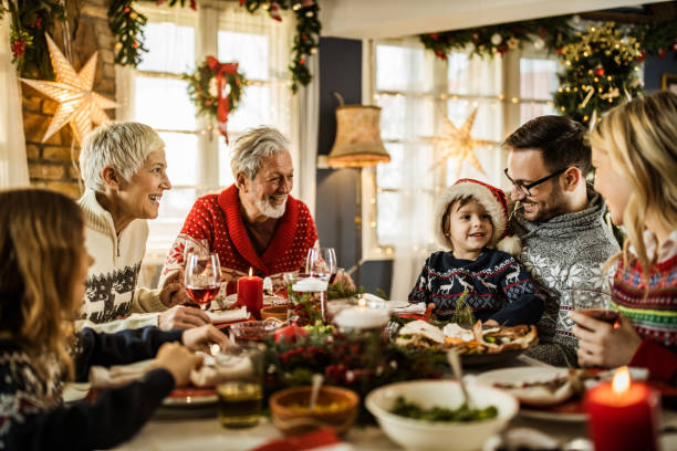 istock Happy extended family talking during New Year's meal at dining table. 1396441925