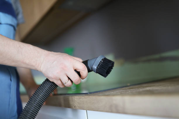 istock Male worker remove dust with vacuum cleaner, nozzle on cleaning device 1396442066