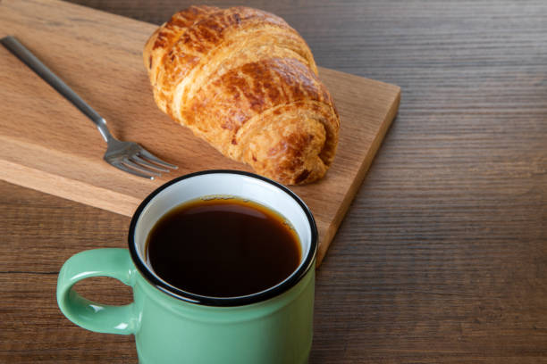 istock Croissant with a cup of full coffee ,directly above 1396442359