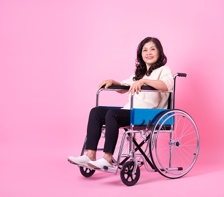 Image of middle aged Asian woman on pink background