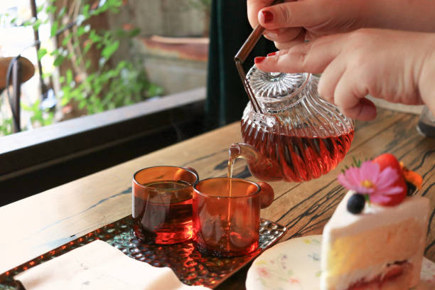 istock pouring two cups of tea 1396446254