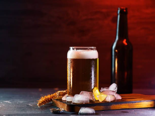 istock A glass of cold beer on a dark table, red backlight copy space 1396447093