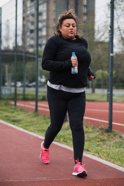 istock Obese Hispanic woman on a run 1396448092
