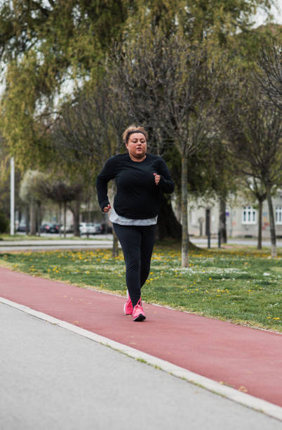 istock Fat Latin woman on a morning jog 1396448094